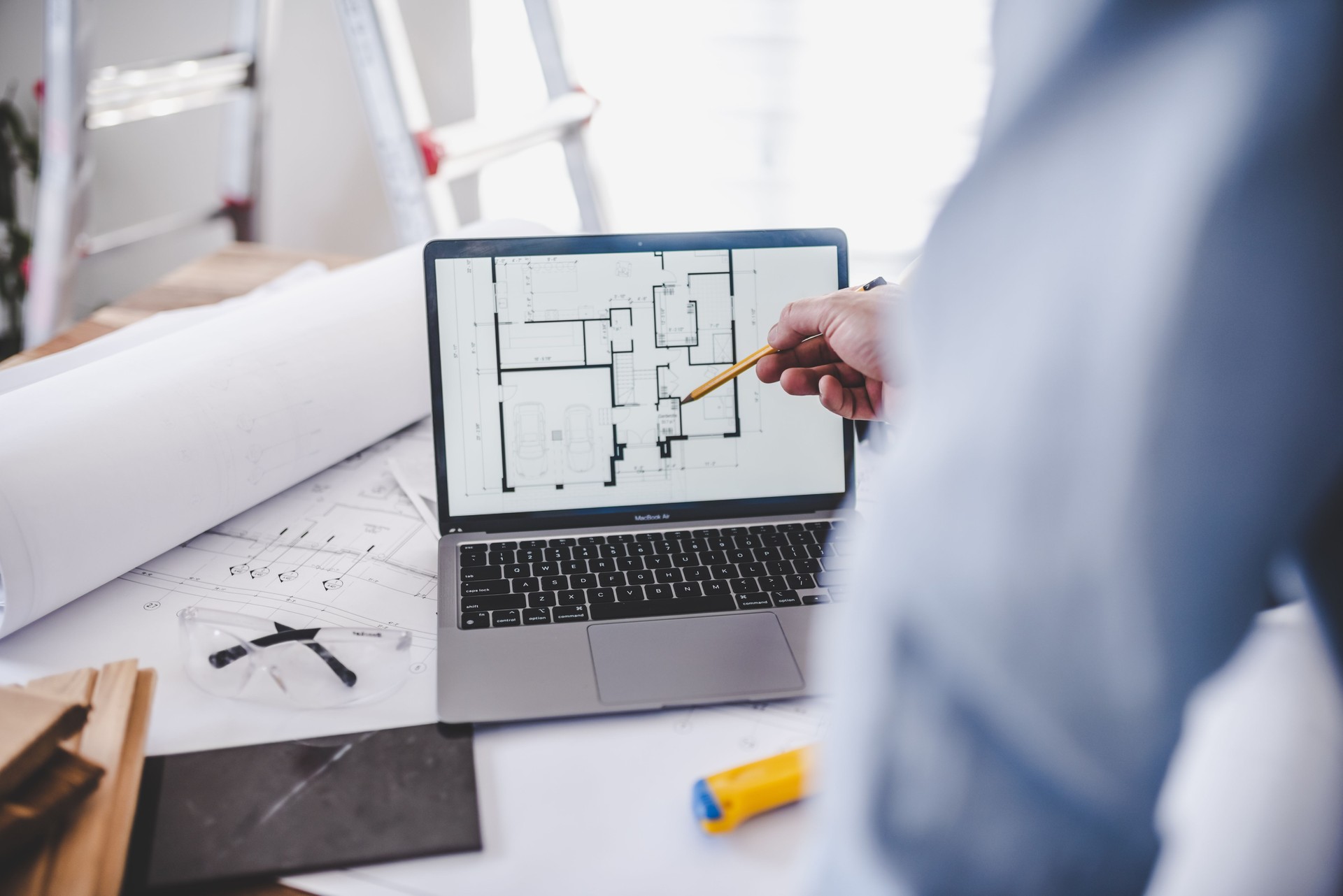 Architect examining a house plan on laptop screen